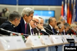 U.S. Secretary of State John Kerry (2nd L) delivers remarks to the OSCE Ministerial Council meeting in Belgrade, Serbia, Dec. 3, 2015.