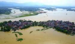 In this photo taken on July 22, 2018, a village is submerged in flood water in the suburb of Hanoi, Vietnam.