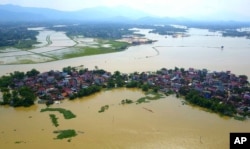 In this photo taken on July 22, 2018, a village is submerged in flood water in the suburb of Hanoi, Vietnam.