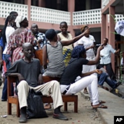 Voters wait for election material to arrive at a polling station in Kinshasa, Congo, November 28, 2011