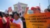 Demonstrators gather at the Supreme Court as the justices finish the term with decisions on gerrymandering and a census case involving a bid by the Trump administration to ask everyone about their citizenship status in the 2020 census, July 27, 2019.