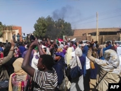 Sudanese protesters chant slogans during an anti-government demonstration in Khartoum's twin city of Omdurman on March 10, 2019.