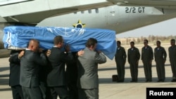 FILE - The crew of a Brazilian military plane stands at attention as the coffin with the body of the U.N. special envoy to Iraq, Sergio Vieira de Mello is put on the plane at the airport in Baghdad, Aug. 22, 2003.