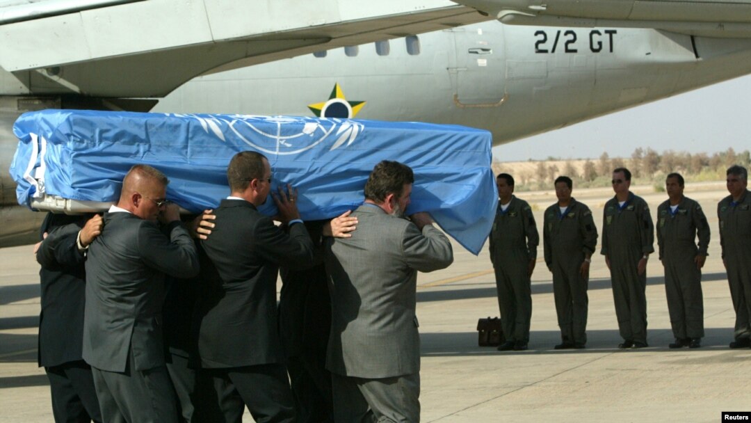 FILE - The crew of a Brazilian military plane stands at attention as the coffin with the body of the U.N. special envoy to Iraq, Sergio Vieira de Mello is put on the plane at the airport in Baghdad, Aug. 22, 2003.
