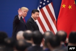 FILE - U.S. President Donald Trump and China's President Xi Jinping leave a business leaders event at the Great Hall of the People in Beijing, Nov. 9, 2017.