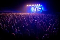 People attend a concert in Barcelona, Spain, March 27, 2021. Five thousand music lovers attended the rock concert after passing a same-day COVID-19 screening to test its effectiveness in preventing outbreaks of the virus at large cultural events.