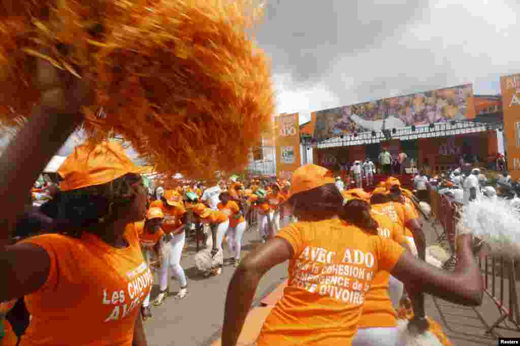 Supporters of Ivory Coast&#39;s President Alassane Ouattara and his party, the Rally of the Houphouetists for Democracy and Peace (RHDP), dance during a campaign rally in Yamoussoukro.&nbsp; Ouattara is heavily favored to win re-election with the Oct. 25 vote.