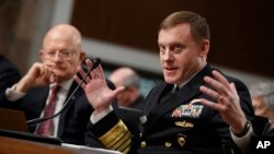 Director of National Intelligence James Clapper listens at left as National Security Agency and Cyber Command chief Adm. Michael Rogers testifies before the Senate Armed Services Committee hearing on Jan. 5, 2017.