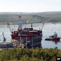 A floating oil platform is tugged from harbor in Russia's northern port of Murmansk August 18, 2011. The Gazprom platform was to embark on from Murmansk port, launching an Arctic oil exploration effort