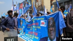 FILE - Supporters of the various political parties that are members of the presidential coalition accompany DRC President Felix Tshisekedi Tshilombo who files his candidacy for the December presidential elections, October 7, 2023.