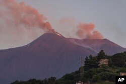 Smoke billows from Mount Etna volcano, the largest of Italy's three active volcanoes, near the Sicilian town of Catania, southern Italy, July 20, 2019.