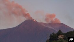 Smoke billows from Mount Etna volcano, the largest of Italy's three active volcanoes, near the Sicilian town of Catania, southern Italy, Saturday, July 20, 2019. 