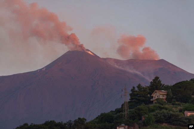 Smoke billows from Mount Etna volcano, the largest of Italy's three active volcanoes, near the Sicilian town of Catania, southern Italy, July 20, 2019.