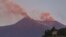 Smoke billows from Mount Etna volcano, the largest of Italy's three active volcanoes, near the Sicilian town of Catania, southern Italy, Saturday, July 20, 2019. 