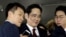 FILE - Jay Y. Lee (center) vice chairman of Samsung Electronics, arrives to be questioned as a suspect in bribery case in the influence-peddling scandal that led to the president's impeachment at the office of the independent counsel in Seoul, South Korea.