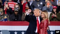 President Donald Trump and first lady Melania Trump prepare to leave a rally for U.S. Senators Kelly Loeffler, R-Ga., and David Perdue, R-Ga., who are both facing runoff elections Saturday, Dec. 5, 2020, in Valdosta, Ga. (AP Photo/Ben Gray)