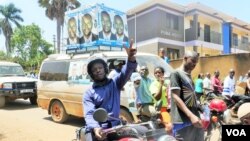 Supporters of opposition leader Kizza Besigye flash the peace sign, or victory sign, to show solidarity with their candidate in the suburb of Ntinda, Uganda, Feb. 16, 2016. (Photo: Lizabeth Paulat for VOA) 