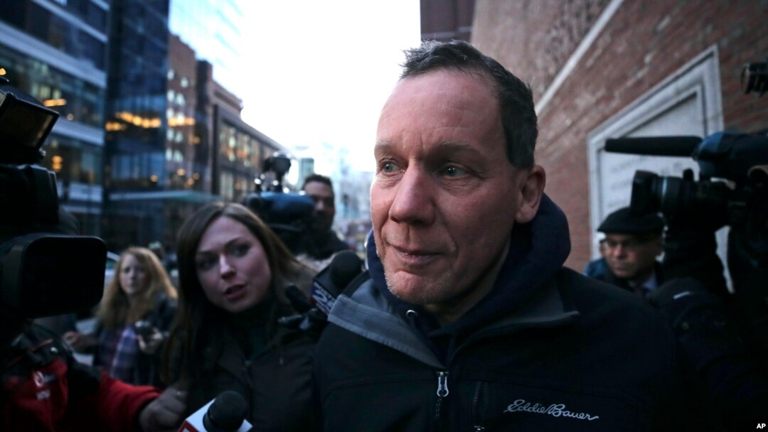 Harvard University professor Charles Lieber is surrounded by reporters as he leaves the Moakley Federal Courthouse in Boston, Jan. 30, 2020. 