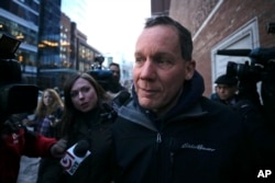 Harvard University professor Charles Lieber is surrounded by reporters as he leaves the Moakley Federal Courthouse in Boston, Jan. 30, 2020.
