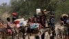 FILE— Sudanese refugees who fled the violence in Sudan's Darfur region and newly arrived ride their donkeys looking for space to temporarily settle, near the border between Sudan and Chad in Goungour, Chad May 8, 2023. 