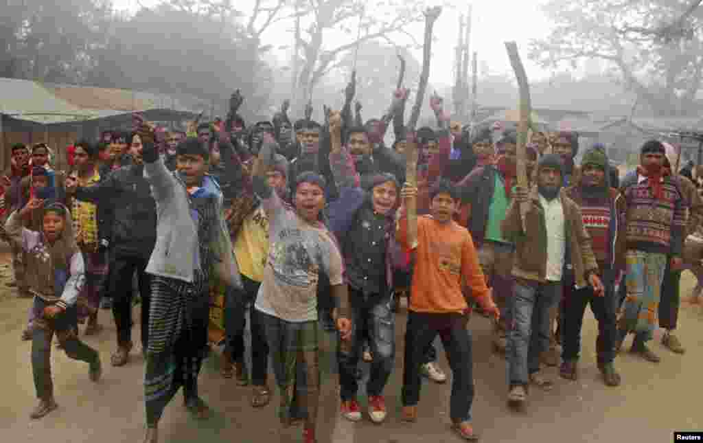 Protesters shout slogans during a clash with police in Gaibandha, Bangladesh, Jan. 5, 2014. 