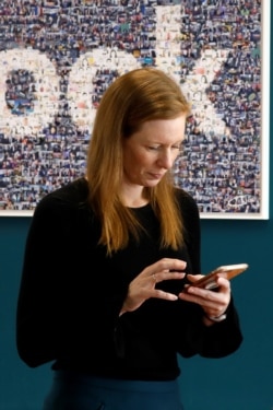 FILE - Monika Bickert, Facebook's head of global policy management checks her mobile phone before attending a content summit at France's Facebook headquarters in Paris, France, May 15, 2018.