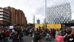 Protesters kneel as they gather in front of the U.S. Embassy during the Black Lives Matter protest rally in London, June 7, 2020, 