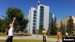 FILE - Students play a game of pickup baseball on campus at the University of Calgary in Calgary, Alberta, August 26, 2010. 