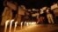 A boy places a candle as demonstrators hold placards during a candlelight march for a gang rape victim, who was assaulted in New Delhi, January 16, 2013. 