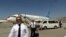 Sekelompok pilot dari maskapai Ariana Afghan tampak berjalan di area Bandara Internasional Hamid Karzai di Kabul, Afghanistan, setelah mendarat pada 5 September 2021. (Foto: AP)