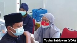 Mahmudi Hariono alias Yusuf sedang divaksin oleh petugas di RSUD Solo. (Foto: VOA/Yudha Satriawan)