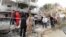 Libyan security forces gather outside the French embassy building in Tripoli following a car bomb attack, April 23, 2013.