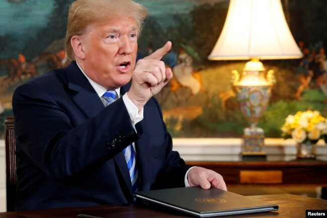 FILE - U.S. President Donald Trump speaks to reporters after signing a proclamation declaring his intention to withdraw from the JCPOA Iran nuclear agreement in the Diplomatic Room at the White House in Washington, May 8, 2018.