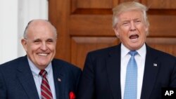 President-elect Donald Trump calls out to media as he and former New York Mayor Rudy Giuliani pose for photographs as Giuliani arrives at the Trump National Golf Club Bedminster clubhouse, Nov. 20, 2016, in Bedminster, N.J.