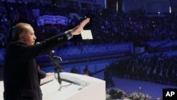 Turkish President Recep Tayyip Erdogan addresses voters in Gaziantep, Turkey, Oct. 24, 2015, in an apparent breach of a law that calls for his neutrality in elections campaigns.