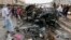 Civilians gather at the scene of a car bomb attack in Kamaliyah neighborhood, a predominantly Shiite area of eastern Baghdad, Iraq, Monday, May 20, 2013.