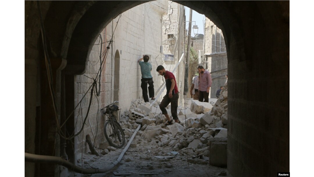 Residents inspect their damaged homes after an airstrike on rebel-held Old Aleppo, Syria, Aug. 15, 2016.