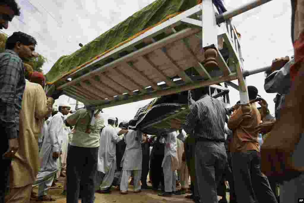 Pakistanis attend the funeral of factory workers in Karachi, Pakistan, September 13, 2012.