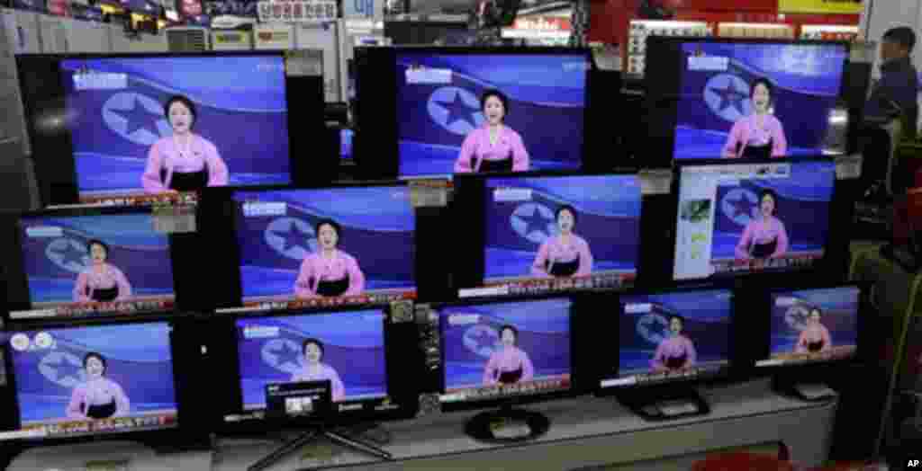 A man watches TV screen showing a North Korean TV anchorwoman announcing the success of a rocket launch, at an electronic shop in Seoul, South Korea, Wednesday, Dec. 12, 2012.