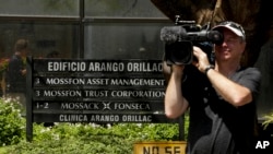 A cameraman films outside the Arango Orillac Building that lists the Mossack Fonseca law firm in Panama City, April 5, 2016. Documents leaked from the firm include details of how some of the globe's richest people funnel assets into secretive shell companies.