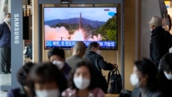 A TV screen showing a news program reporting about North Korea's missile launch with file footage is seen at a train station in Seoul, South Korea, Oct. 19, 2021.