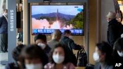 A TV screen showing a news program reporting about North Korea's missile launch with file footage is seen at a train station in Seoul, South Korea, Oct. 19, 2021.