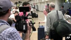 In this image made from video, U.S. citizen and aid worker Heidi Linton of Christian Friends of Korea, second from right, speaks to reporters after arriving at Beijing International Airport from Pyongyang, North Korea, Aug. 31, 2017.