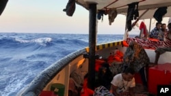 boat as it arrives near Lampedusa coast in the Mediterranean Sea, Aug.15, 2019. 