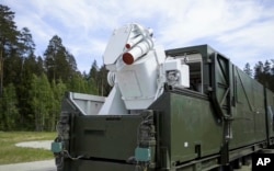 In this video grab provided by RU-RTR Russian television via AP television, March 1, 2018, a Russian military truck with a laser weapon mounted on it is shown at an undisclosed location in Russia. President Vladimir Putin declared Thursday that Russia has developed a range of new nuclear weapons, claiming they can't be intercepted by the enemy.