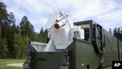 In this video grab provided by RU-RTR Russian television via AP television, March 1, 2018, a Russian military truck with a laser weapon mounted on it is shown at an undisclosed location in Russia.