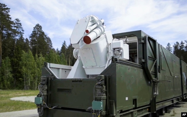 In this video grab provided by RU-RTR Russian television via AP television, March 1, 2018, a Russian military truck with a laser weapon mounted on it is shown at an undisclosed location in Russia. President Vladimir Putin declared Thursday that Russia has developed a range of new nuclear weapons, claiming they can't be intercepted by the enemy.