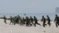 FILE - U.S. and Philippine marines storm the beach to simulate a raid during the joint U.S.-Philippines military exercise at the Naval Training Exercise Command in Zambales province, northwest of Manila, May 9, 2014.