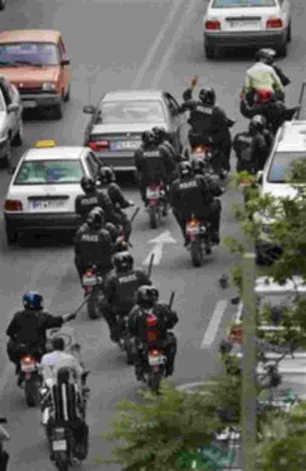 Iranian riot police on motorcycles roam the streets seeking to break up groups of supporters of reformist candidate Mir Hossein Mousavi, protesting the declared results of the Iranian presidential election in Tehran, Iran, Saturday, June 13, 2009. (AP Ph