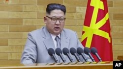 In this image made from video released by KRT on Jan. 1, 2018, North Korean leader Kim Jong Un delivers his annual address from an undisclosed location in North Korea.